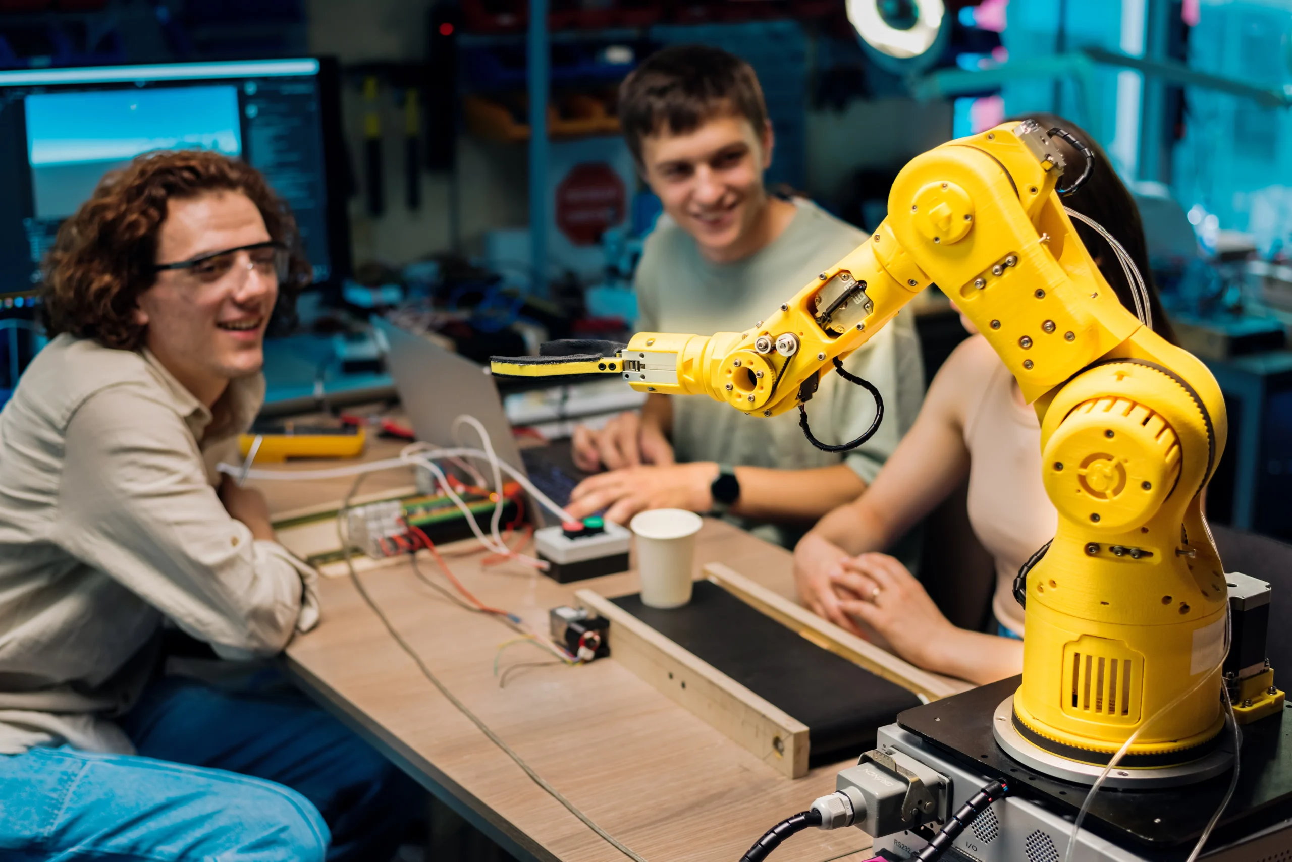 Technical design team at Pixerts performing UX research and programming on a collaborative robotic arm.